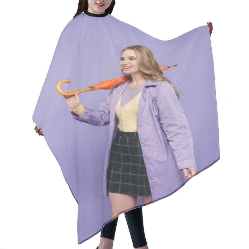 Personality  Positive Young Woman In Trench Coat Standing With Orange Umbrella Isolated On Purple  Hair Cutting Cape