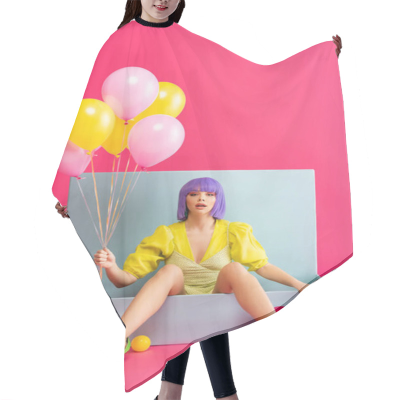 Personality  Emotional Girl In Purple Wig As Doll Holding Balloons And Sitting In Blue Box With Balls And Shopping Bags, On Pink Hair Cutting Cape