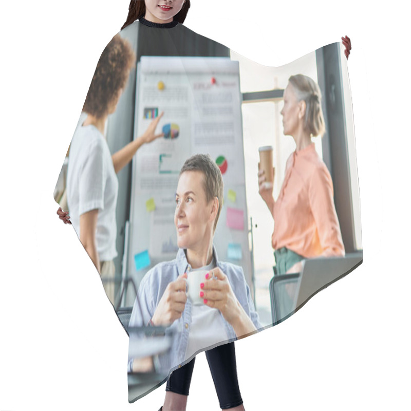 Personality  Devoted Businesswoman Engrossed In Work On A Laptop Computer, With Her Diverse Colleagues On Backdrop. Hair Cutting Cape