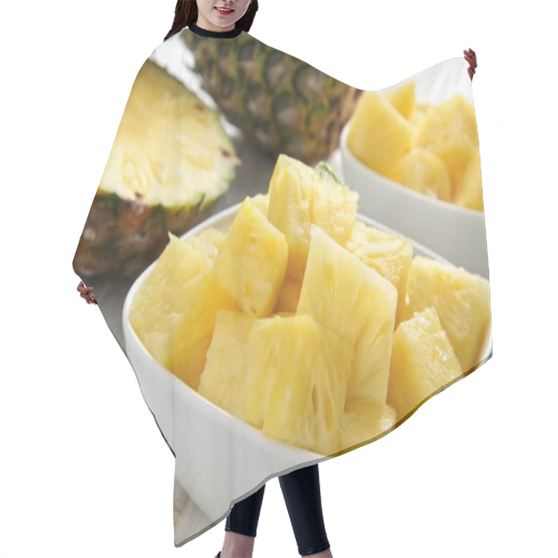 Personality  A Photo Of A Still Life Featuring A Close-up Of A Bowl Filled With Fresh, Yellow Pineapple Slices. The Bowl Is White And Placed On A Surface With A Patterned Cloth Underneath. A Partially Sliced Pineapple Lies Next To The Bowl. The Background Consist Hair Cutting Cape