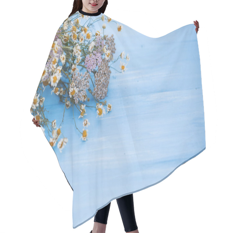 Personality  Beautiful Dried Flowers On Blue Wooden Background. Hair Cutting Cape