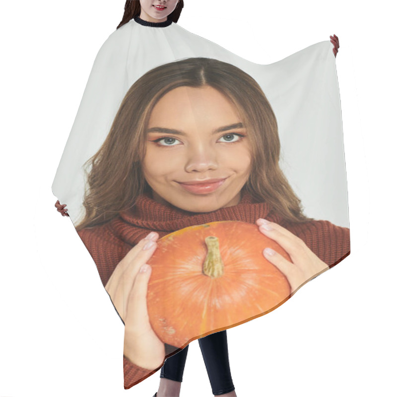 Personality  A Young, Beautiful Woman Smiles While Holding A Vibrant Pumpkin, Embracing The Halloween Vibes. Hair Cutting Cape