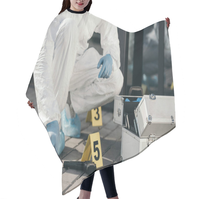 Personality  Cropped View Of Male Criminologist In Protective Suit And Latex Gloves Sitting Near Evidence Gun Hair Cutting Cape