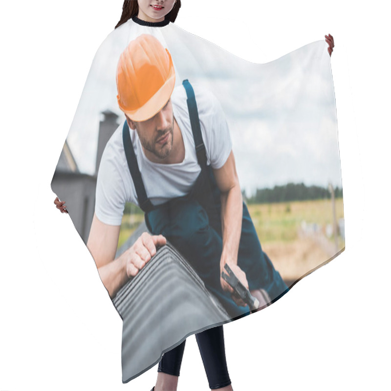 Personality  Selective Focus Of Repairman In Orange Helmet Sitting On Roof And Holding Hammer  Hair Cutting Cape