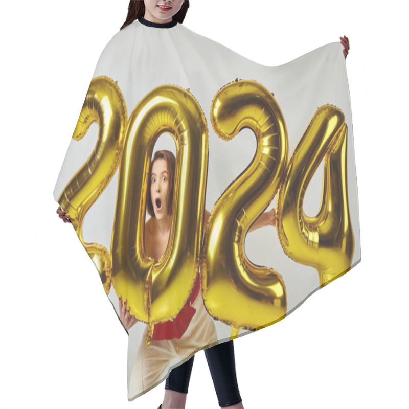 Personality  Happy New Year, Astonished Young Woman In Trendy Attire Holding Balloons With 2024 Numbers On Grey Hair Cutting Cape