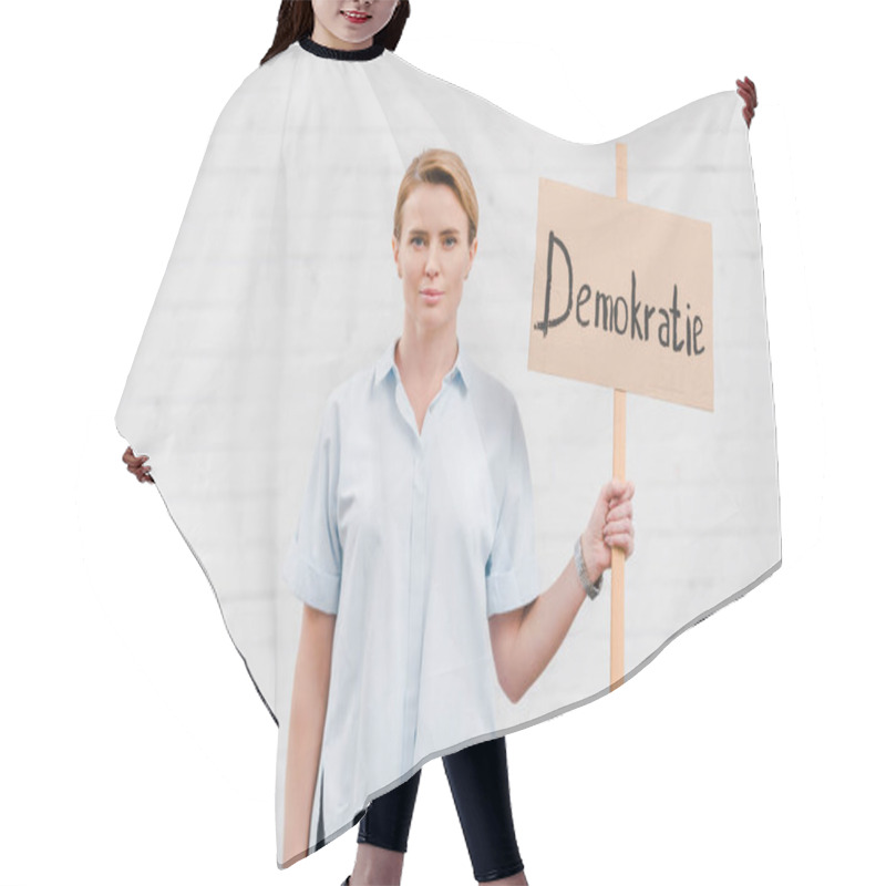 Personality  Attractive Woman Holding Placard With Demokratie Lettering Near Brick Wall  Hair Cutting Cape