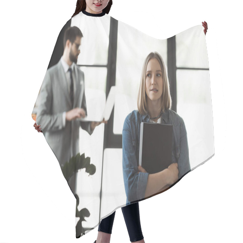 Personality  Nervous Woman Holding Resume Near Blurred Businessman In Office  Hair Cutting Cape