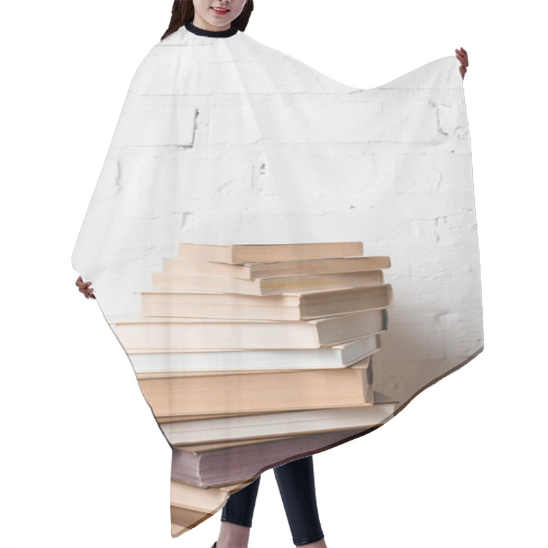 Personality  Pile Of Books Near White Brick Wall With Copy Space Hair Cutting Cape