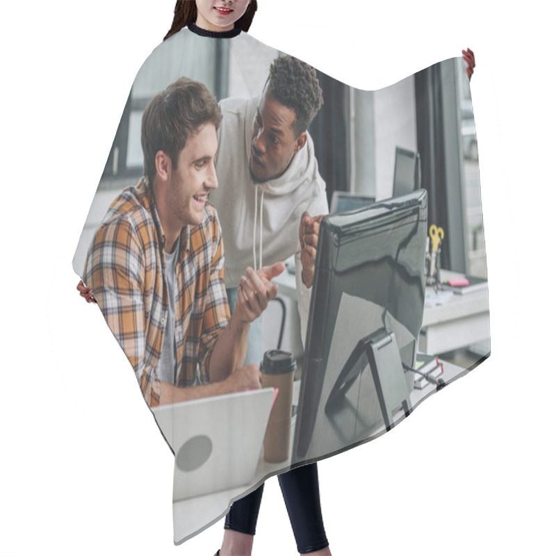 Personality  Two Smiling Multicultural Programmers Pointing At Computer Monitor While Working In Office Together Hair Cutting Cape