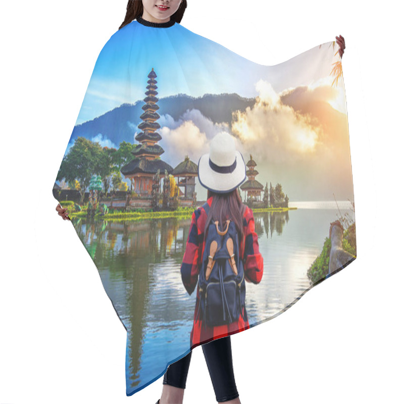 Personality  Woman Traveler With Backpack Looking To Pura Ulun Danu Bratan Temple In Bali, Indonesia. Hair Cutting Cape