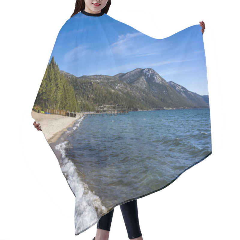 Personality  Lake Tahoe Beach During The Day. Waves Crash Into The Sand. Snow Tops Peaks Of Mountains In The Background.  Hair Cutting Cape