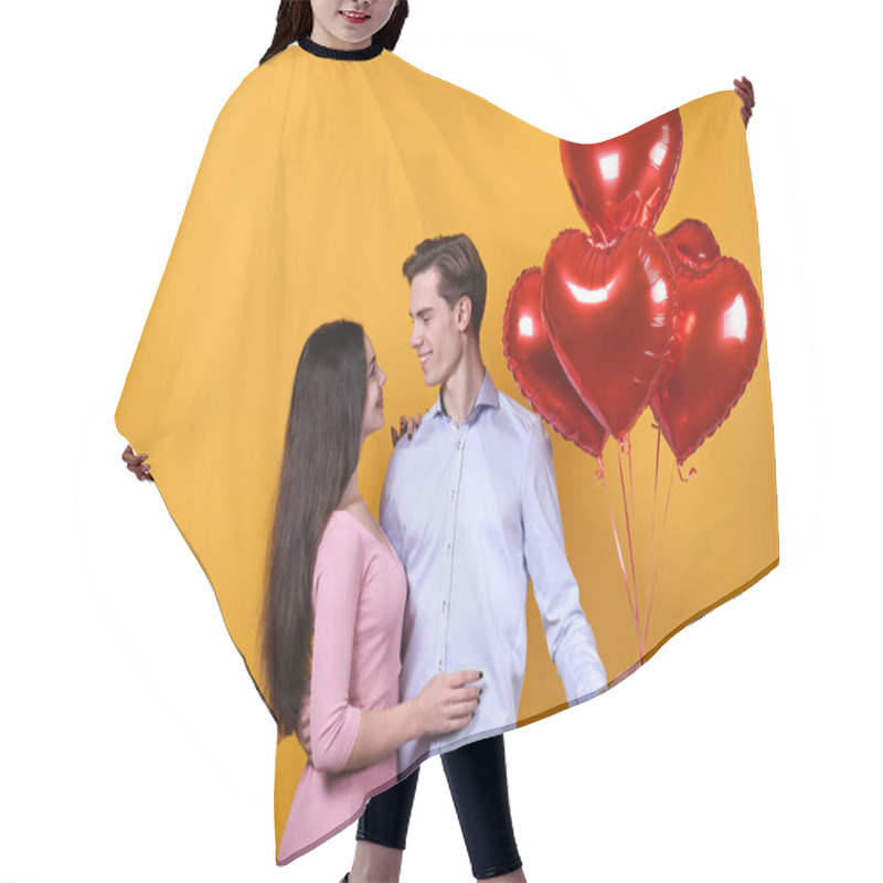 Personality  Happy Valentine's Day Concept. Studio Shot Of Couple In Love Holding A Heart Shaped Balloon, Showing Affection. 14th February - The Lovers Day. Yellow Wall Background, Copy Space, Front View Portrait. Hair Cutting Cape