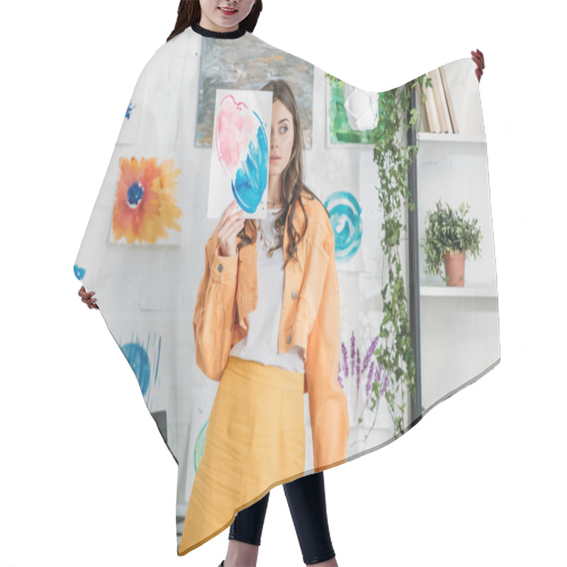 Personality  Beautiful Girl Hiding Face Behind Painting While Standing In Spacious Room Decorated With Green Plants And Drawings On White Wall Hair Cutting Cape