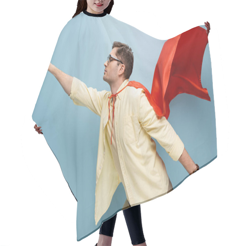 Personality  Side View Of Superhero In Glasses And Red Cape Standing With Outstretched Hand On Blue Hair Cutting Cape