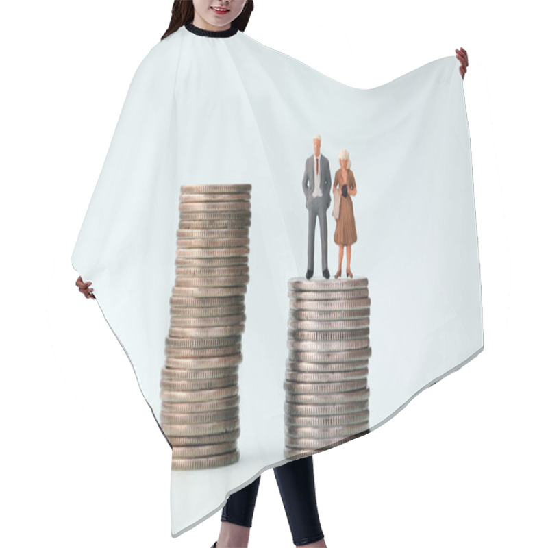 Personality  A Miniature Man And A Miniature Woman Standing In A Pile Of Small Coins. Hair Cutting Cape