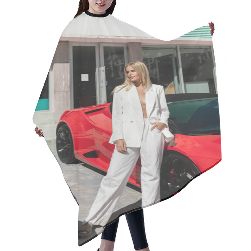 Personality  A Young, Beautiful Blonde Woman Standing Confidently Next To A Vibrant Red Sports Car In Miami. Hair Cutting Cape