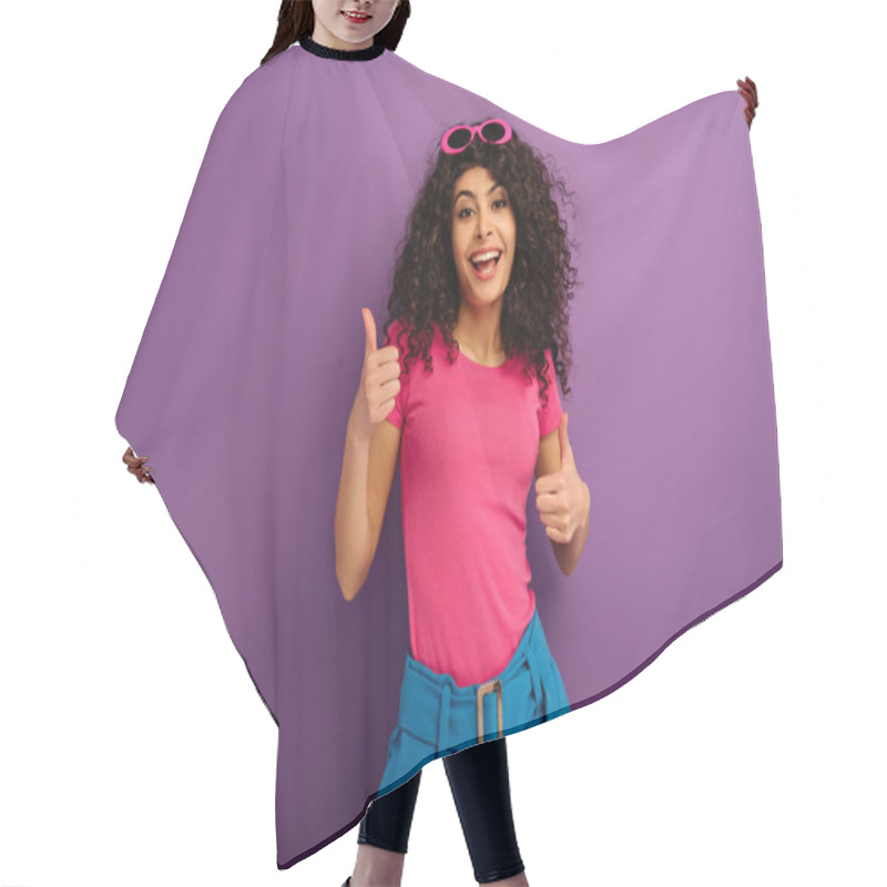 Personality  Cheerful Bi-racial Girl Showing Thumbs Up While Smiling At Camera On Purple Background Hair Cutting Cape