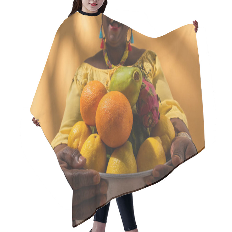 Personality  Partial View Of Middle Aged African American Woman Holding Metal Bowl With Fruits On Orange Hair Cutting Cape