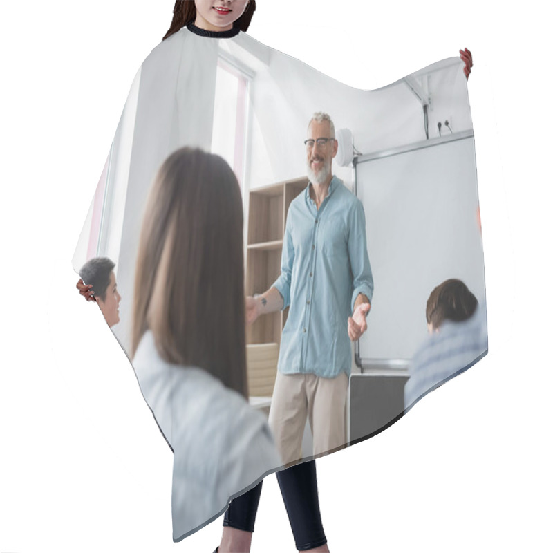 Personality  Positive Teacher Gesturing While Speaking Near Teenagers During Lesson In School Hair Cutting Cape