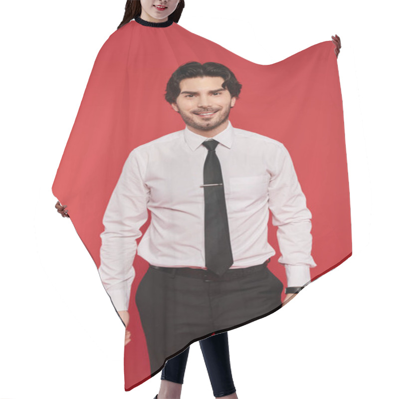 Personality  Confident Young Man Wearing A Dress Shirt And Tie Smiles Brightly In Front Of A Bold Red Backdrop. Hair Cutting Cape