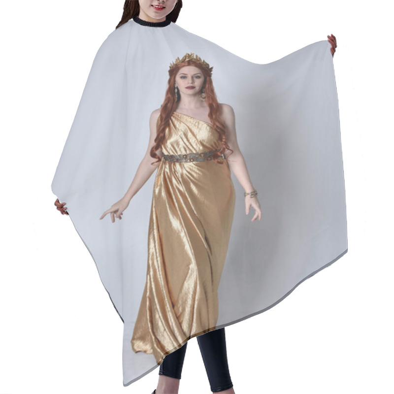 Personality  Full Length Portrait Of Girl With Red Hair Wearing Long Grecian Toga And Golden Wreath. Standing Pose Iisolated Against A Grey Studio Background. Hair Cutting Cape