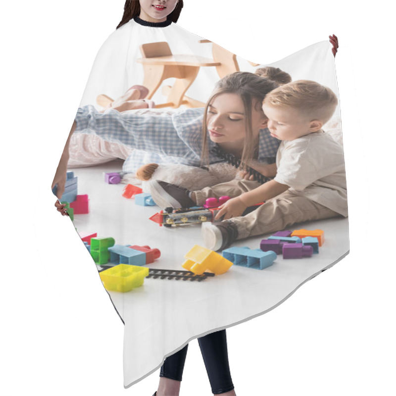 Personality  Young Woman And Toddler Boy Playing With Construction Cubes And Toy Railway On White Hair Cutting Cape