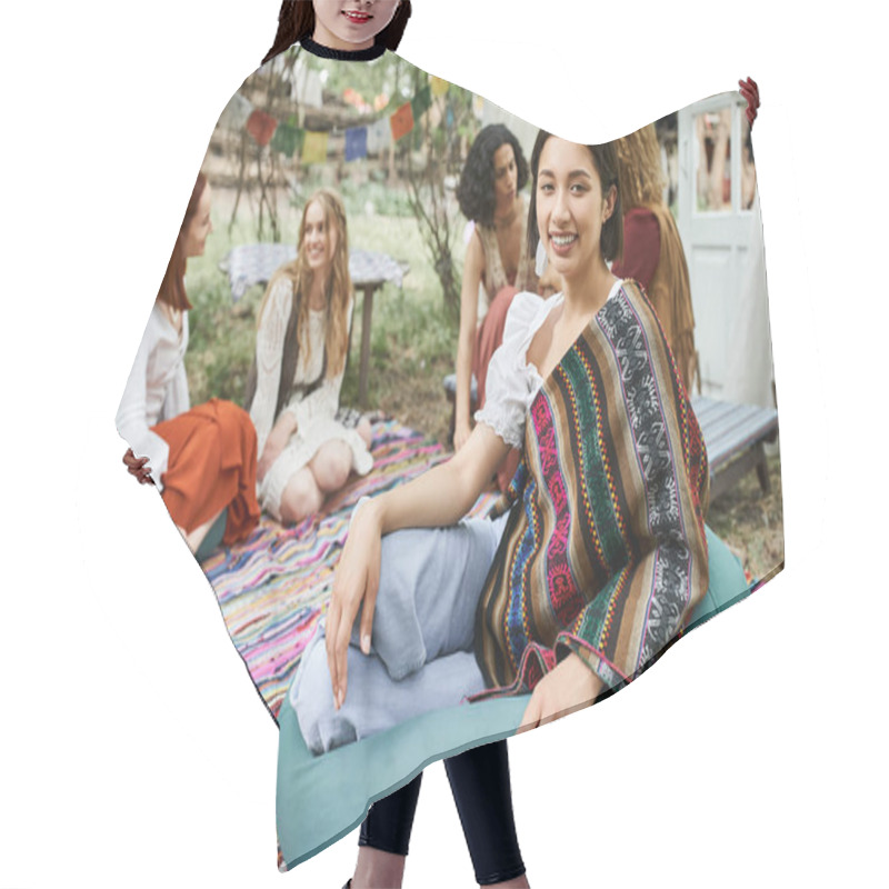 Personality  Smiling Young Woman In Boho Outfit Looking At Camera Near Multiethnic Friends In Retreat Center Hair Cutting Cape