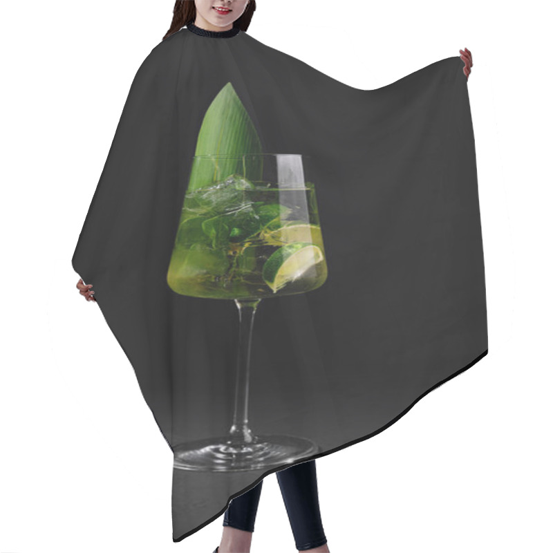 Personality  Elegant Stemware Glass With A Vibrant Cocktail Garnished With Lime And A Tropical Leaf On A Dark Background Hair Cutting Cape