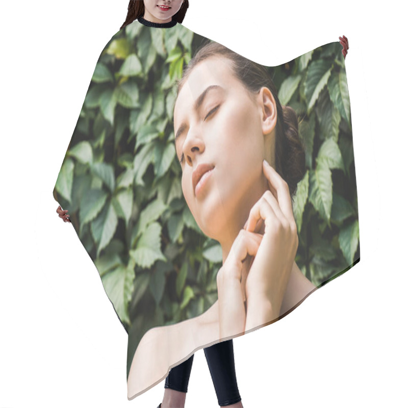 Personality  Young Woman With Hands Near Face On Green Leaves Background  Hair Cutting Cape