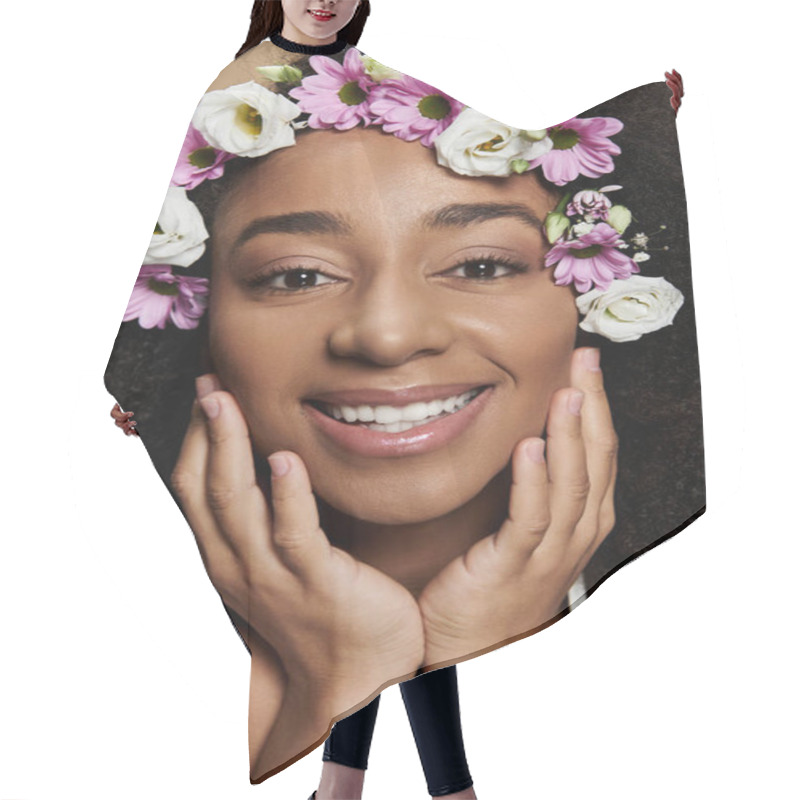 Personality  A Beautiful African American Woman With Natural Makeup And Flowers In Her Hair Smiles Brightly Against A Beige Background. Hair Cutting Cape