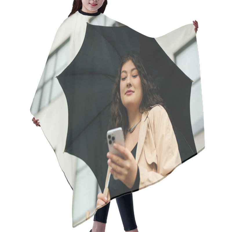 Personality  A Plus Size Woman In A Stylish Black Dress And Trench Coat Checks Her Phone While Enjoying Autumn Outdoors. Hair Cutting Cape