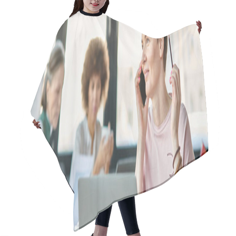 Personality  Dedicated Woman Engrossed In Work, With A Laptop In Front Of Her, With Her Diverse Colleagues On Backdrop, Pride Flag. Hair Cutting Cape