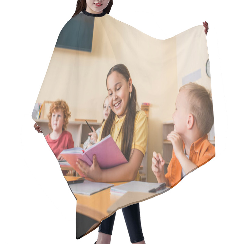 Personality  Happy Asian Girl Reading Book Near Friends During Lesson In Montessori School Hair Cutting Cape