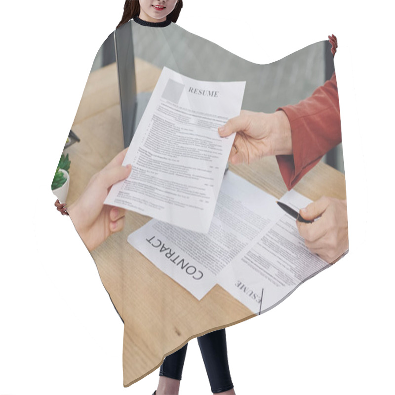 Personality  A Man Hands A Resume To A Woman During A Job Interview. Hair Cutting Cape