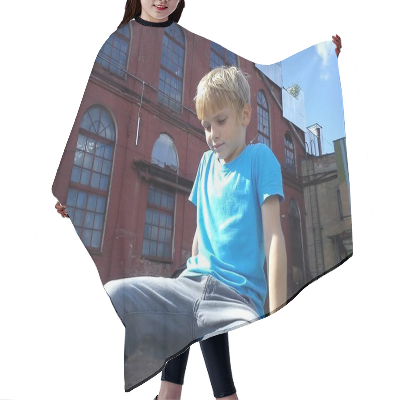 Personality  A Blond-haired Boy In A Blue T-shirt And Gray Trousers Plays On The Street Next To An Old Factory. The Child Climbed On Something And Looks Down. In The Background An Old Brick Building And Sky Hair Cutting Cape