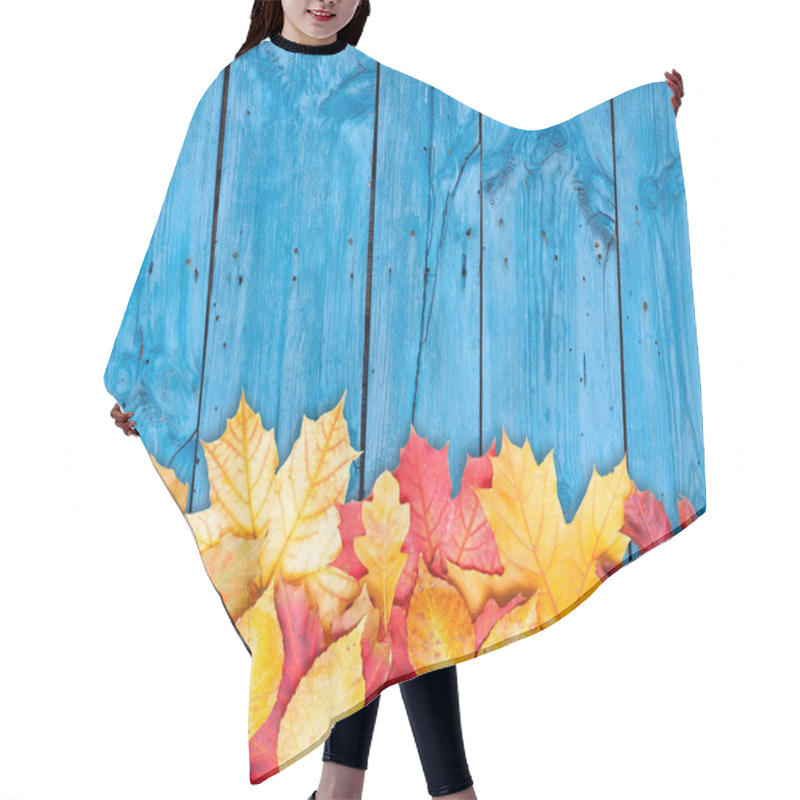 Personality  Autumn Leaves Over Wooden Background. Copy Space. Hair Cutting Cape