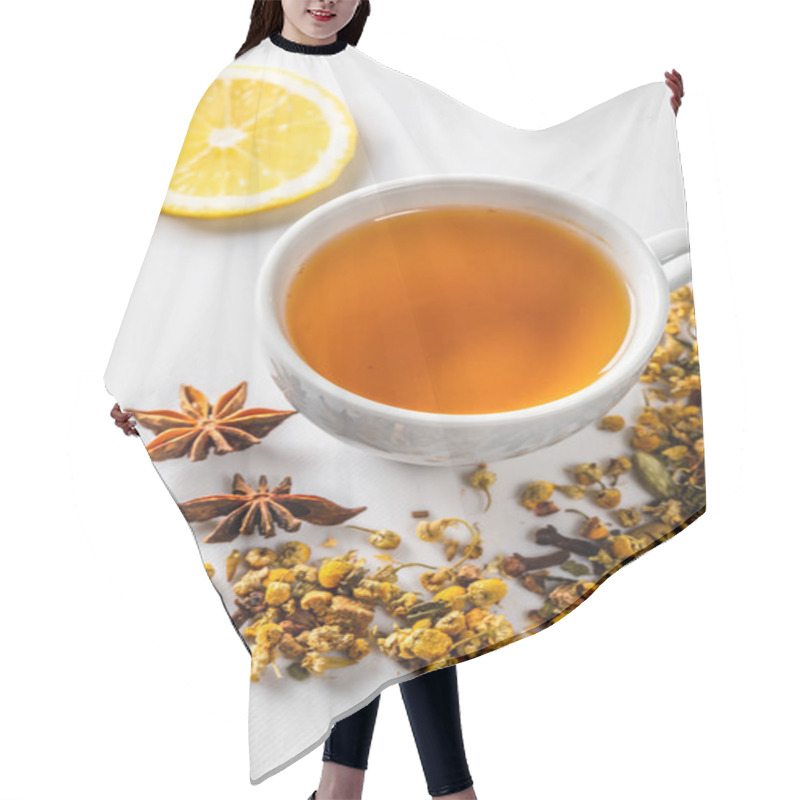 Personality  A Cup Of Green Tea With Dried Chamomile Flowers And A Slice Of Cut Lemon On A White Background. Diet And Healthy Drink. Flatley. Top View Hair Cutting Cape