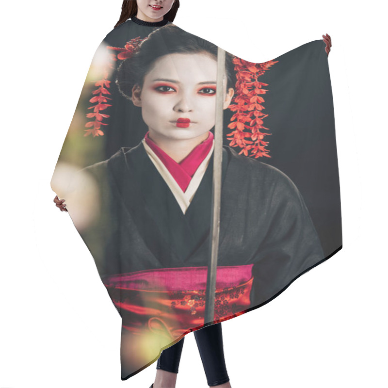 Personality  Selective Focus Of Confident Geisha In Black Kimono Holding Katana And Sakura Branches Isolated On Black Hair Cutting Cape