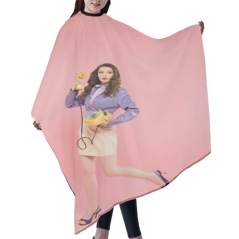 Personality  Doll Concept, Young Woman With Wavy Hair Holding Handset And Yellow Retro Phone, Trendy Outfit, Brunette Model In Purple Jacket Posing And Looking Away On Pink Background, Studio Shot, Full Length  Hair Cutting Cape