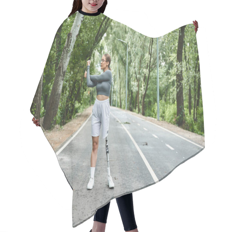 Personality  A Young Woman With A Prosthetic Leg Exercises Outdoors, Embracing A Healthy Lifestyle Surrounded By Trees. Hair Cutting Cape