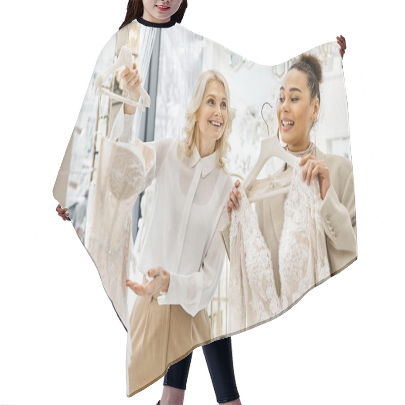 Personality  Young Women, One A Beautiful Bride, Holding Up Dresses In A Store, Assisted By A Shop Attendant. Hair Cutting Cape