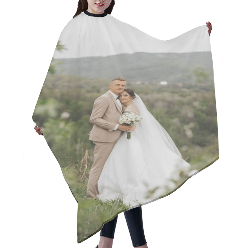 Personality  A Bride And Groom Are Standing On A Grassy Hillside, Posing For A Picture. The Bride Is Wearing A White Dress And The Groom Is Wearing A Suit. They Are Holding A Bouquet And A Bouquet Of Flowers Hair Cutting Cape