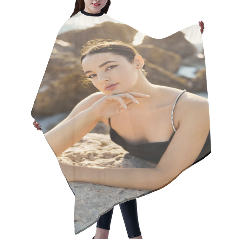 Personality  A Young Woman In A Black Sundress Relaxes On A Rock By The Ocean On Miami Beach. Hair Cutting Cape