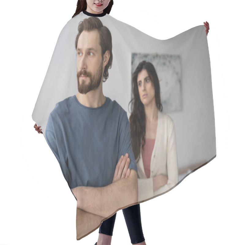 Personality  Angry Man Crossing Arms Near Blurred Girlfriend In Bedroom  Hair Cutting Cape