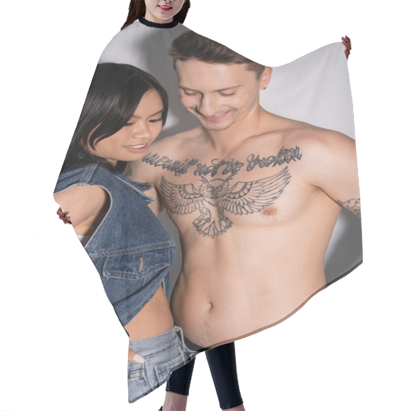 Personality  Positive Tattooed Man And Asian Woman In Denim Clothes Posing On Grey Background Hair Cutting Cape