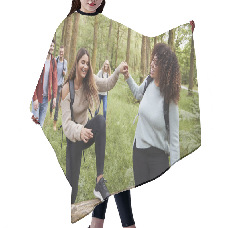 Personality  Young Woman Helping Girlfriend Stepping Over A Fallen Tree During A Hike With Friends In A Forest Hair Cutting Cape