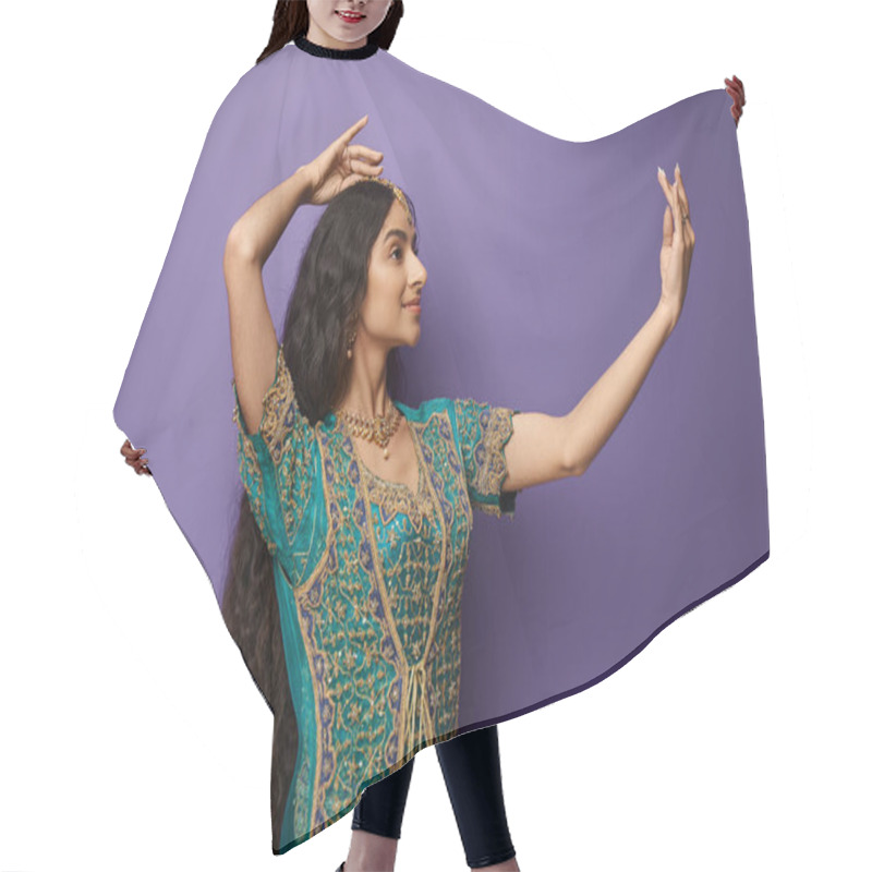 Personality  Attractive Young Indian Woman In National Costume Gesturing While Dancing On Purple Backdrop Hair Cutting Cape