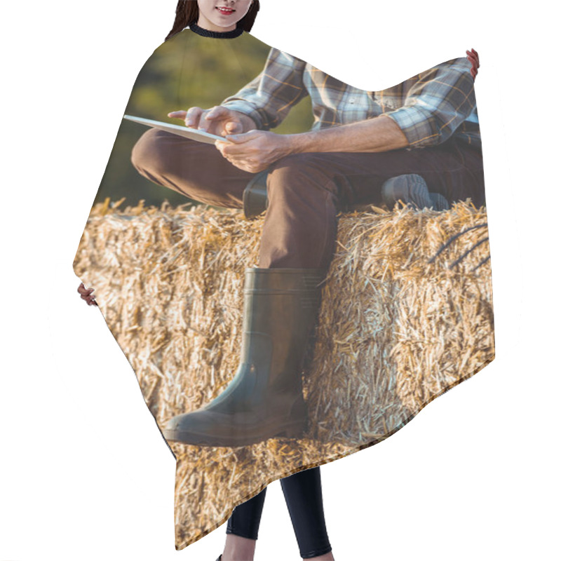 Personality  Cropped View Of Self-employed Farmer Using Digital Tablet While Sitting On Bale Of Hay  Hair Cutting Cape