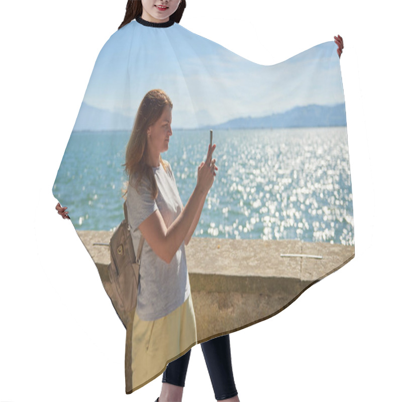 Personality  Woman Capturing Scenic Photos By A Sparkling Lake On A Sunny Day With Majestic Mountain Views. Idyllic Lakeside Setting Showcases Natural Beauty And Outdoor Adventure In A Serene European Landscape Hair Cutting Cape