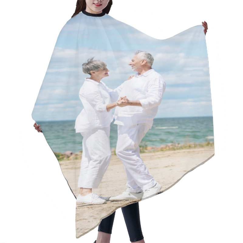 Personality  Full Length View Of Happy Senior Couple Looking At Each Other While Dancing At Beach Hair Cutting Cape